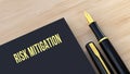 Risk Mitigation text message on notepad.Fountain pen and wooden background 3D rendering Royalty Free Stock Photo