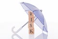 Risk wooden blocks under umbrella