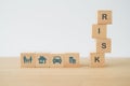 Risk word on wooden cube blocks and family, house, car, coins icon for life and health, property, travel, and business insurance Royalty Free Stock Photo