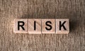 RISK. Word written on wooden blocks on a brown background Royalty Free Stock Photo