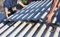 Risks of Asbestos Roofs, Asbestos Roof Removal. Asbestos removal roof works. House with old, danger asbestos roof tiles repair