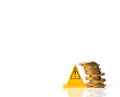 Risky coin stack and Warning label on white background.Financial crisis concept. Royalty Free Stock Photo