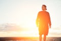 Risky man standing on the top of the roof at sunset Royalty Free Stock Photo