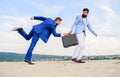 Risky transaction. Businessman takes away briefcase from business partner. Fraud and extortion concept. Men suits Royalty Free Stock Photo