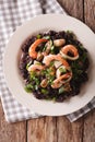 Risotto of black rice with seafood close up on a plate. Vertical Royalty Free Stock Photo