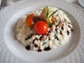 Risotto with seafood, cherry tomatoes and balsamic vinegar