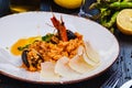 Risotto with seafood and parmesan cheese on white plate