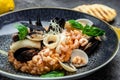 Risotto with seafood shrimp and mussels in shells. Mediterranean cuisine. Restaurant menu, dieting, cookbook recipe top view