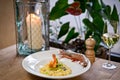 Risotto with shrimps and asparagus and tiger shrimp. In a white plate. and glass of white wine. On a rustic wooden table Royalty Free Stock Photo