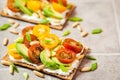 ÃÂ¡risp bread toast with cream cheese, fresh avocado, cherry tom Royalty Free Stock Photo