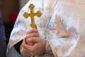 The rite of baptism - the golden cross is in the Orthodox priest hands