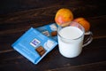 Ritter Sport milk chocolate in blue package, glass mug with milk, two noctarines - Saint Petersburg, Russia, August 2020