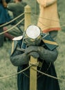 RITTER WEG, MOROZOVO, APRIL 2017: Festival of the European Middle Ages. Weary knight in helmet and chainmail resting after battle Royalty Free Stock Photo