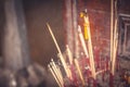 Ritual burning aroma sticks and candles in religious asian Buddhism temple