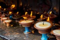Ritual candles on the altar at the buddhist temple Royalty Free Stock Photo