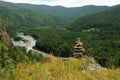 A ritual stone pyramid on top of a mountain overlooking a beautiful winding river flowing through the taiga Royalty Free Stock Photo