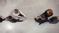 Rival business man and woman compete for the command by pulling the rope Royalty Free Stock Photo