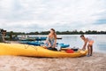 Cute loving couple getting ready for memorable river adventure