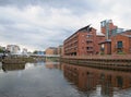 The river aire joined to the leeds liverpool canal in the clarence dock area with buildings reflected in the water locks and Royalty Free Stock Photo