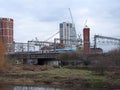 The river aire in leeds taken from the footpath showing the south bank and holbeck with a train on the railway tracks in between