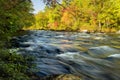 river in the autumn colorful forest on a sunny autumn warm day. USA. Long exposure, blurry water cascades in motion. Royalty Free Stock Photo