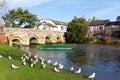 River Avon Christchurch Dorset England UK with bridge and green boat