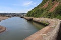 The river Axe flows quickly as it travels towards the sea looking back towards the marina and the yacht club Royalty Free Stock Photo