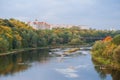 River on the background of the autumn forest and residential area. Forest river reflection autumn landscape. Autumn forest river Royalty Free Stock Photo