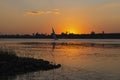 River bank  and felluca silhouette at dusk sunset Royalty Free Stock Photo