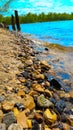 The river Bank is rocky.Clean water.In the background, the forest and the blue sky. Royalty Free Stock Photo