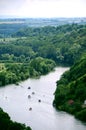 River bend with several motor boats framed by forest