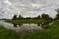 River bend, undefined building far on the other bank.