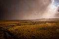 The river Bes near Nasbinals ,on the aubrac plateau Lozere , France . showing stormy Skys and rain with the sun just showing