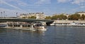 A River Boat full of Tourists making its way down the River Seine