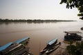 River Boats tied up to pier alon river bank with view to other shore in Puerto Maldonado in Peru and the Amazon Royalty Free Stock Photo