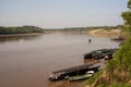 River Boats tied up to pier river bank with view to other shore in Puerto Maldonado in Peru and the Amazon