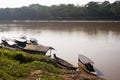 River Boats tied up to pier river bank with view to other shore in Puerto Maldonado in Peru and the Amazon