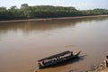 River Boats tied up to pier along river bank with view to other shore in Puerto Maldonado in Peru and the Amazon Royalty Free Stock Photo