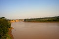 River Boats tied up to pier along river bank with view to other shore in Puerto Maldonado in Peru and the Amazon Royalty Free Stock Photo