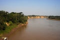 River Boats tied up to pier along river bank with view to other shore in Puerto Maldonado in Peru and the Amazon Royalty Free Stock Photo