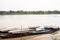 River Boats tied up to pier along river bank with view to other shore in Puerto Maldonado in Peru and the Amazon Royalty Free Stock Photo