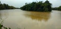 a river that branches over a dam with dirty and calm water a good fishing spot Royalty Free Stock Photo