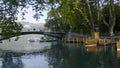 A river with a bridge in the Park of Europe. Action. Beautiful view of the pavement in the Park with boats and people in