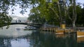 A river with a bridge in the Park of Europe. Action. Beautiful view of the pavement in the Park with boats and people in