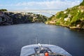 A river, a bridge, roofs of houses and a large white pleasure cruise boat in the light of the setting sun