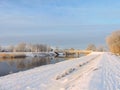 River, bridge and snowy winter trees in Rusne island, Lithuania