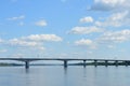River bridge. Sunny weather. The sky, clouds scatter light. The wind drives numerous clouds across