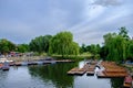 River Cam in Cambridge, England with moored punts at the shore and people enjoying themselves Royalty Free Stock Photo