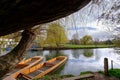 River Cam in Cambridge, England with moored punts at the shore Royalty Free Stock Photo