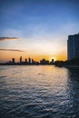 River city view landscape at twilight sunset. Boat on river with tranquil water. Hochiminh city Saigon vietnam cityscape building Royalty Free Stock Photo